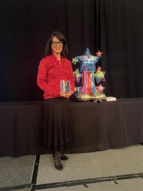 Woman holding award